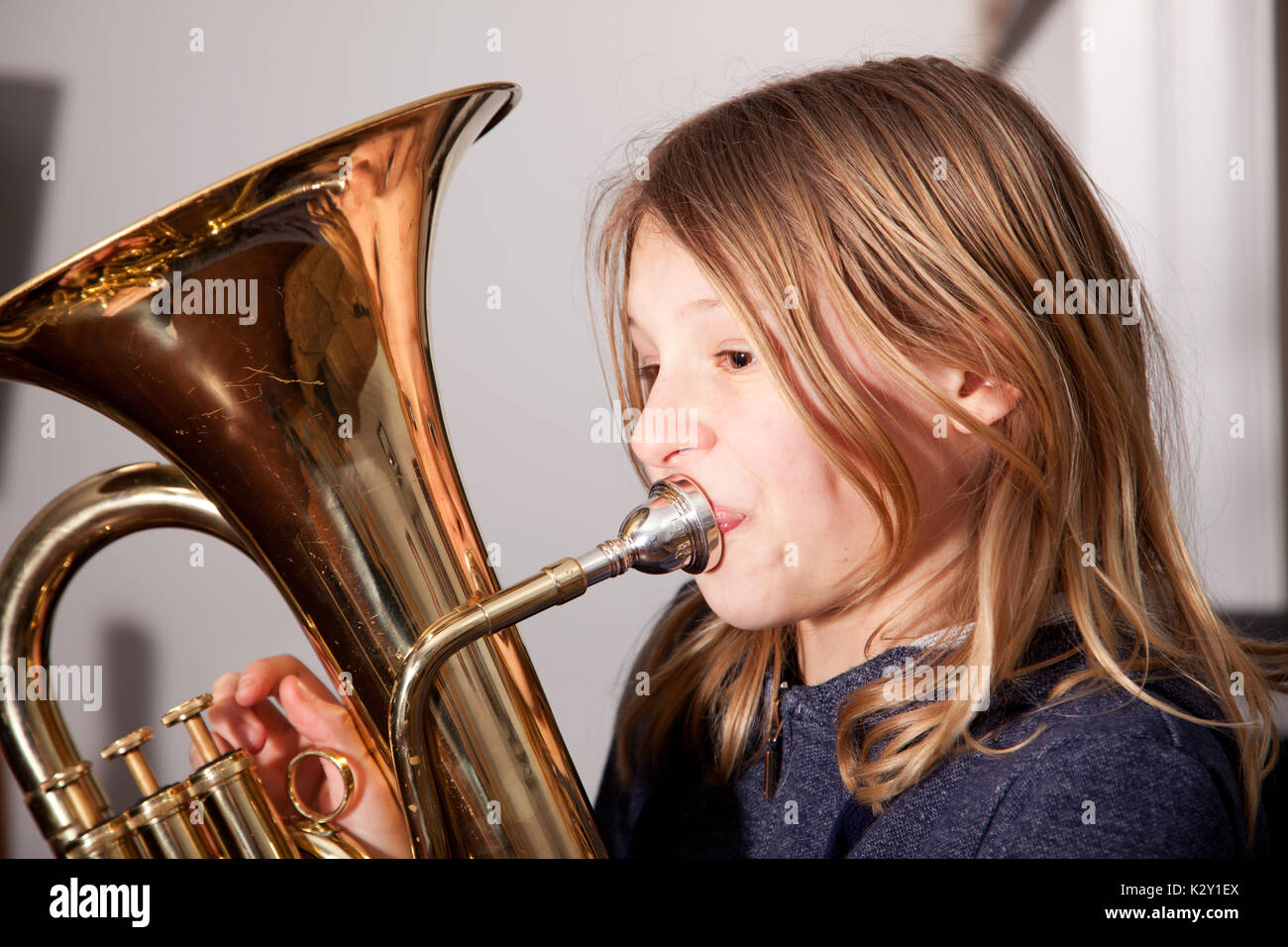 Profile of young girl playing baritone instrument Stock Photo - Alamy