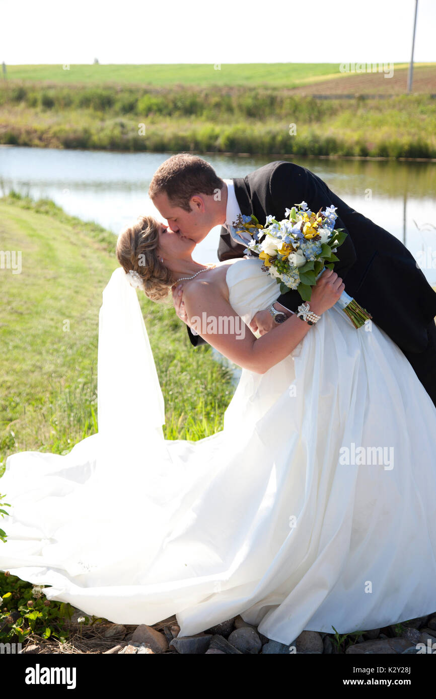 a bride and groom dance and dip in a long kiss Stock Photo Alamy