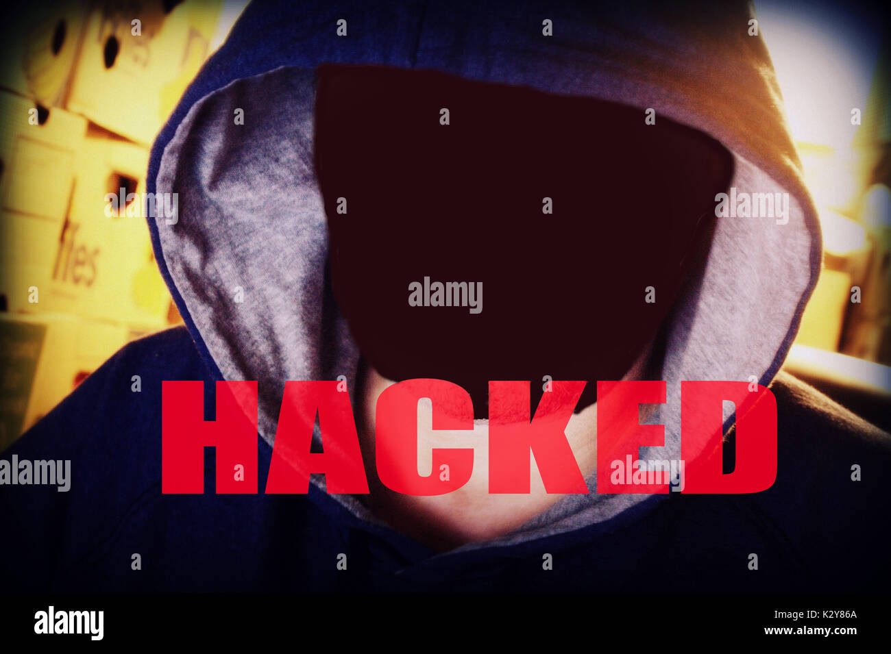 Hacker hacked victim perpetrator computer scam ransom ware terrorist terror anonymous blacked out face Stock Photo