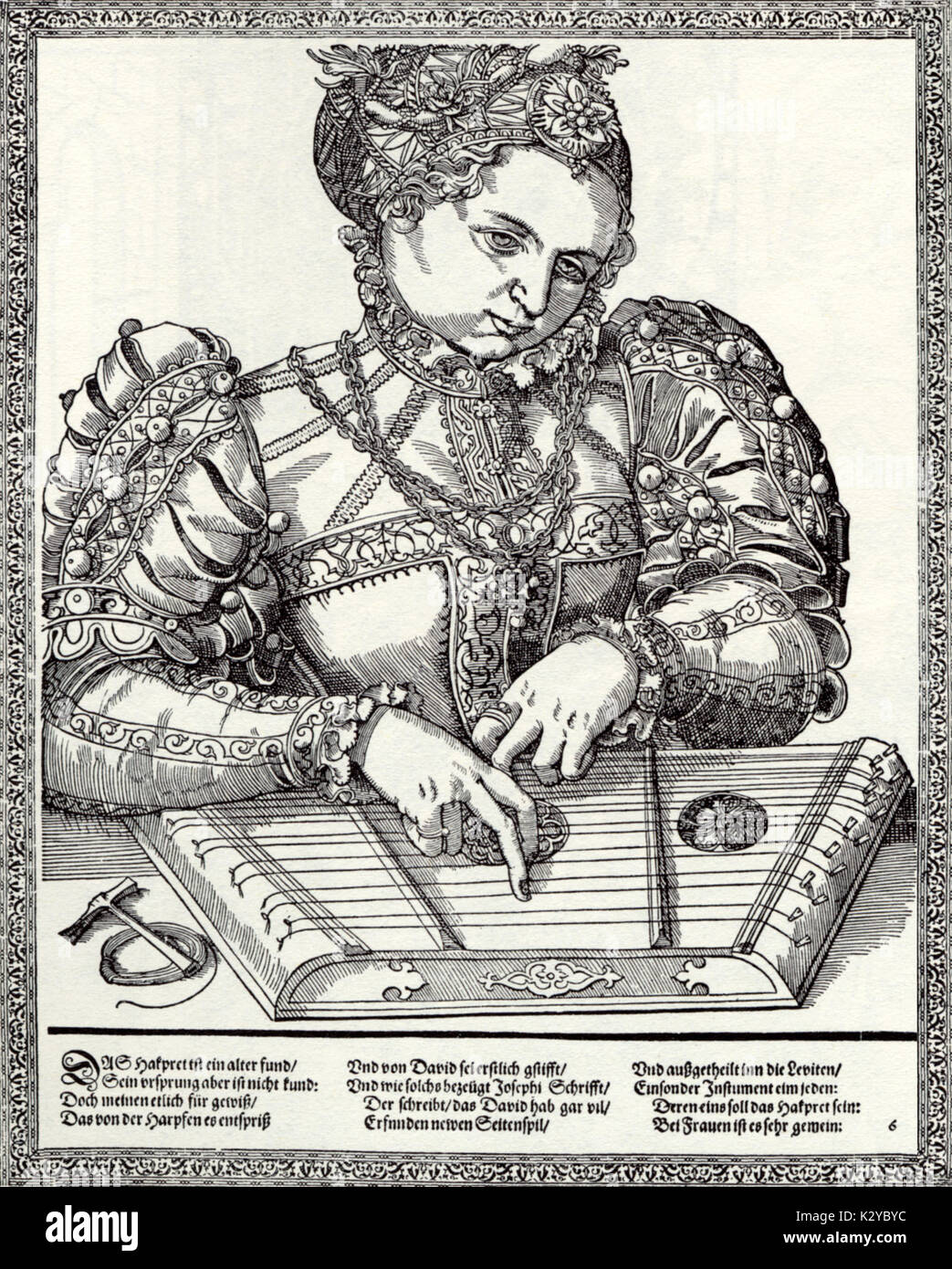 Woman playing psaltery. Mid-16th century German engraving. Tuner and spare string at side. Stock Photo