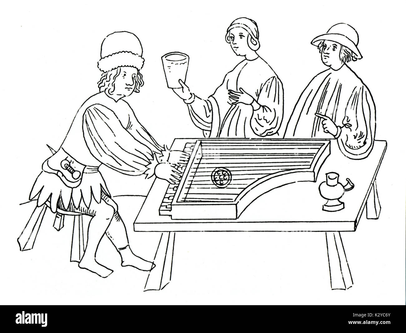 Primitive spinet in 1440, from the Weimar  'Wunderbuch' (miracle book). [Small harpsichord, pentagonal in shape, with a single manual.] Stock Photo