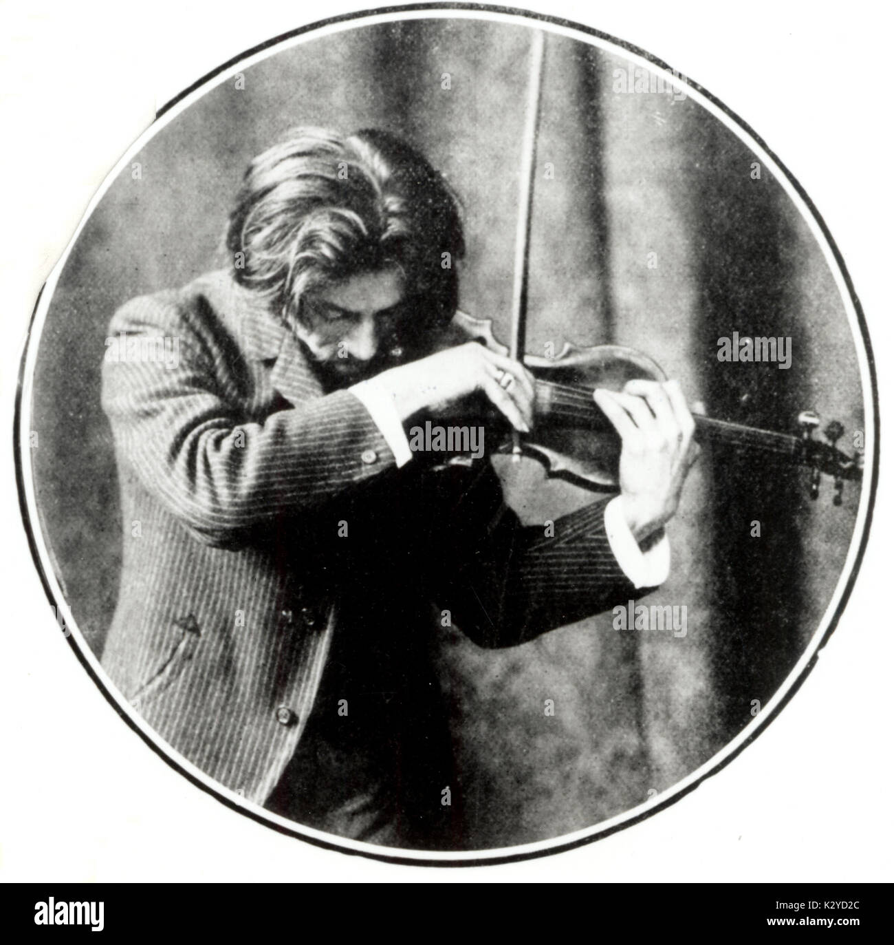 THIBAUD, Jacques - tuning his violin Thibaud's violin was one of the most famous Stradivari. French violinist (1880-1953). Stock Photo
