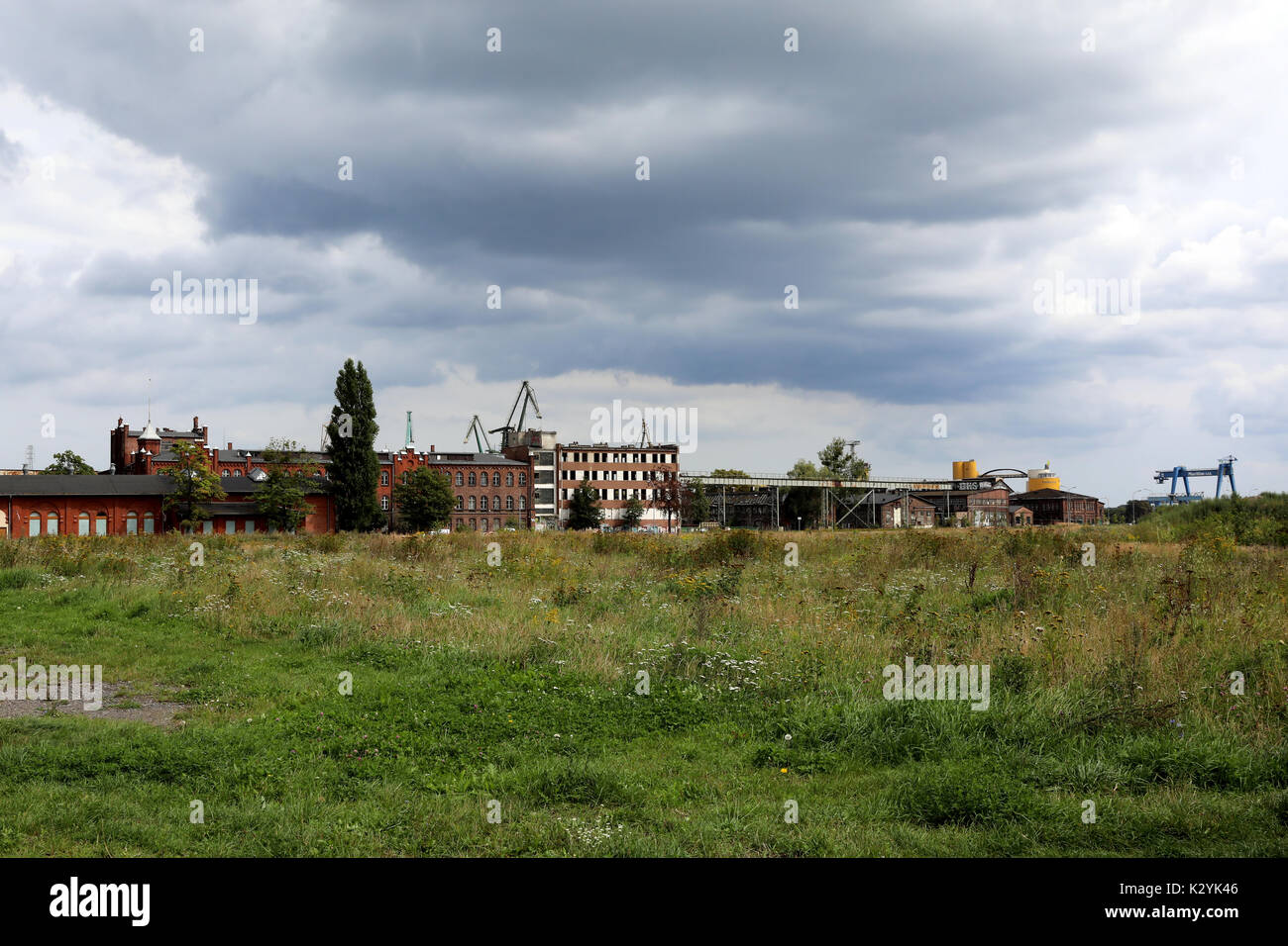 Warehouses and cranes dominate the landscape around the Port of Gdańsk, Poland, on 20 August 2017. Stock Photo