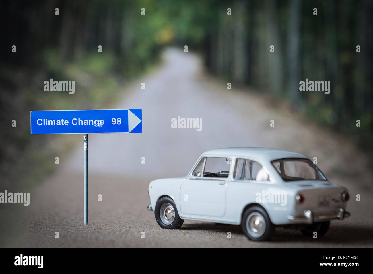 Miniature car on the road, choose address climate change, conceptual image global decisions Stock Photo