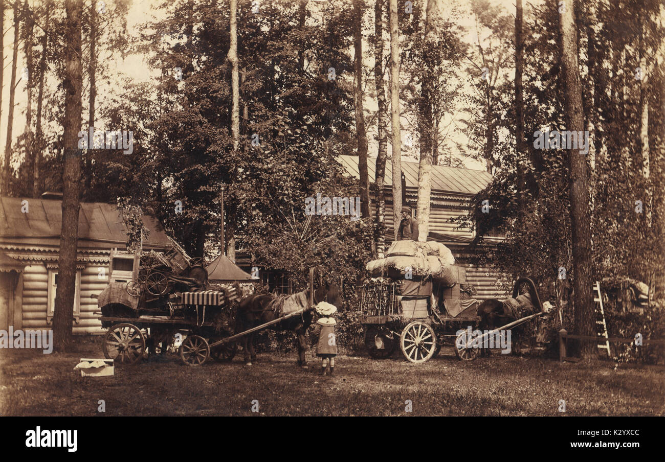 Carts with loaded things for  leaving to the city after summer rest. Vintage photo, Russia, 1905 Stock Photo
