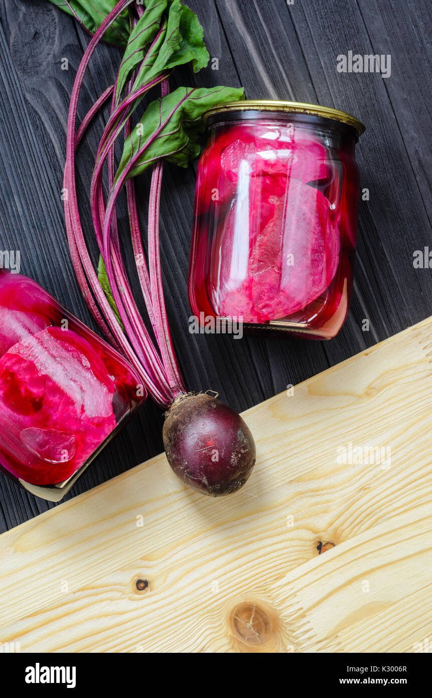 Canned homemade beetroot in clear glass jars with fresh organic ...