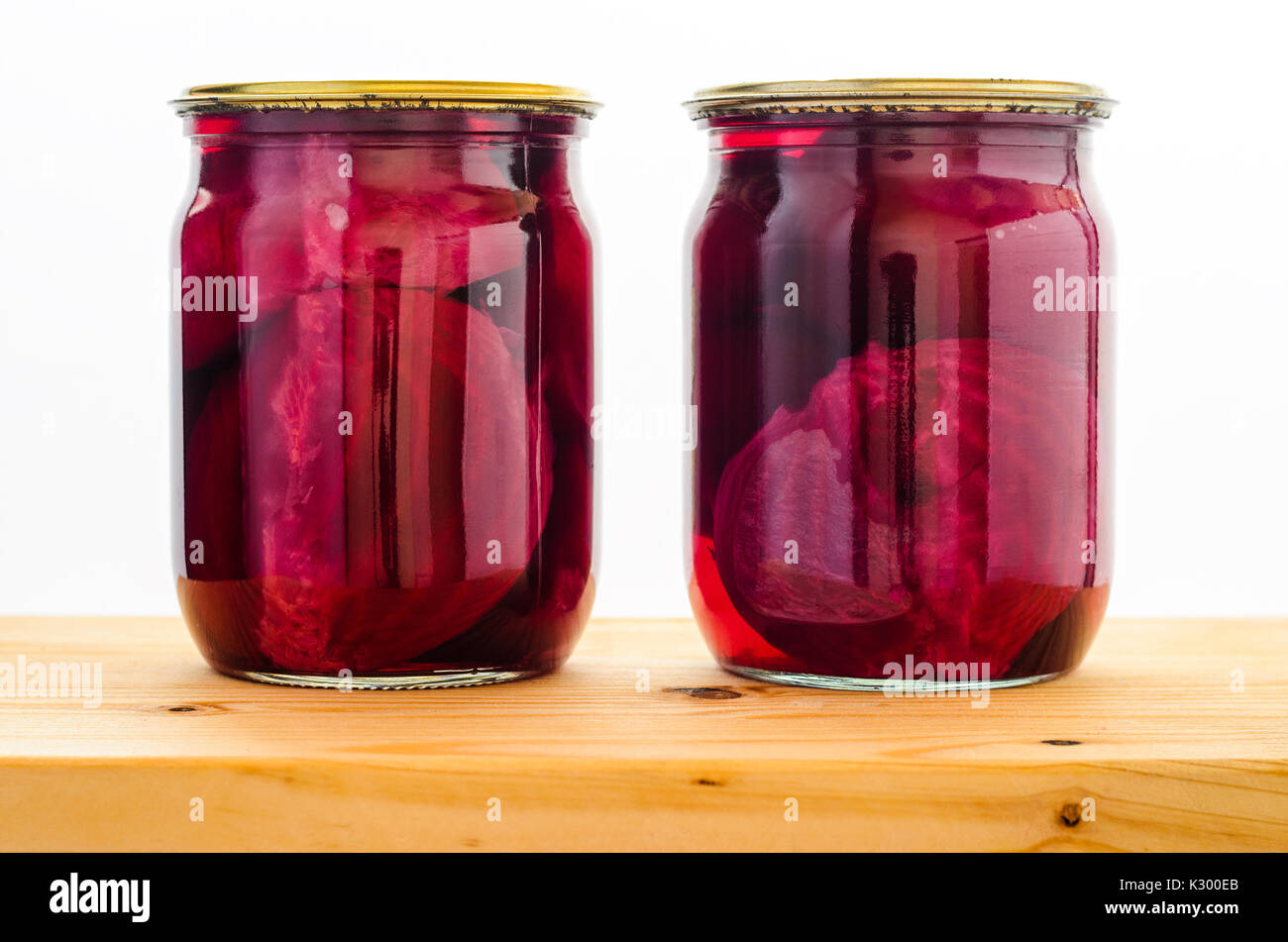 Canned beets in a two glass jars on wooden table on white background Stock Photo Alamy
