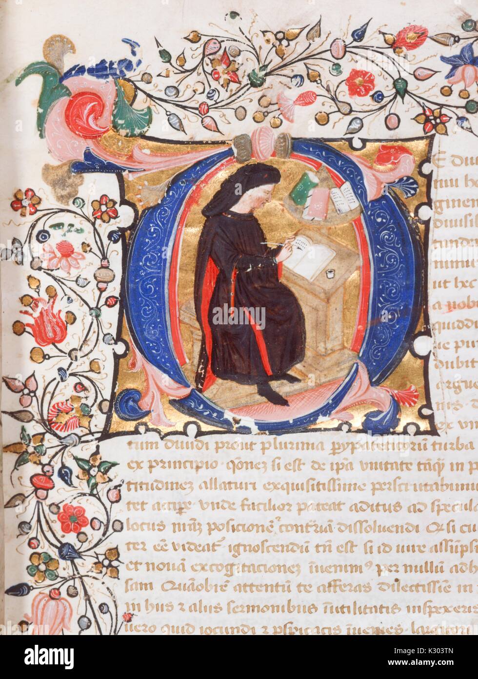 Illuminated manuscript page containing text, an ornate border, and an illustration of a scribe at work, from la ate 14th century Latin manuscript book written in Italy, 1380. Stock Photo