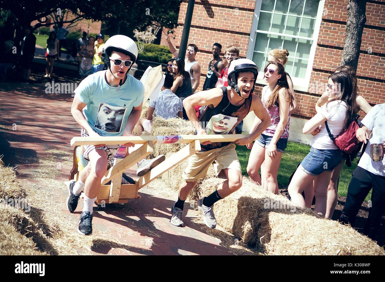 College students compete in the annual Red Bull Chariot Race at the 2016 Spring Fair, an annual festival featuring music, food, vendors, and various other forms of entertainment on the Johns Hopkins University's Homewood campus in Baltimore, Maryland, April, 2016. Courtesy Eric Chen. Stock Photo