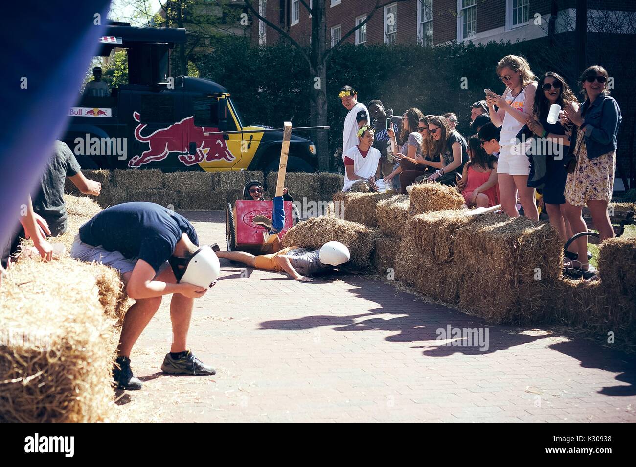 College students compete in the annual Red Bull Chariot Race at the 2016 Spring Fair, an annual festival featuring music, food, vendors, and various other forms of entertainment on the Johns Hopkins University's Homewood campus in Baltimore, Maryland, April, 2016. Courtesy Eric Chen. Stock Photo