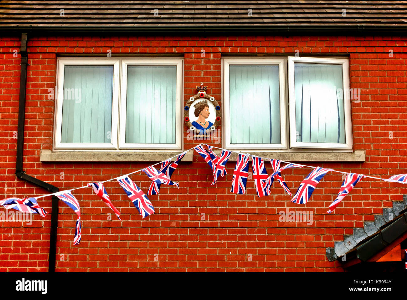Terrace of a unionist house decorated with Union Jack flags and Queen Elizabeth II painting. Belfast, Northern Ireland, United Kingdom, UK, Europe Stock Photo