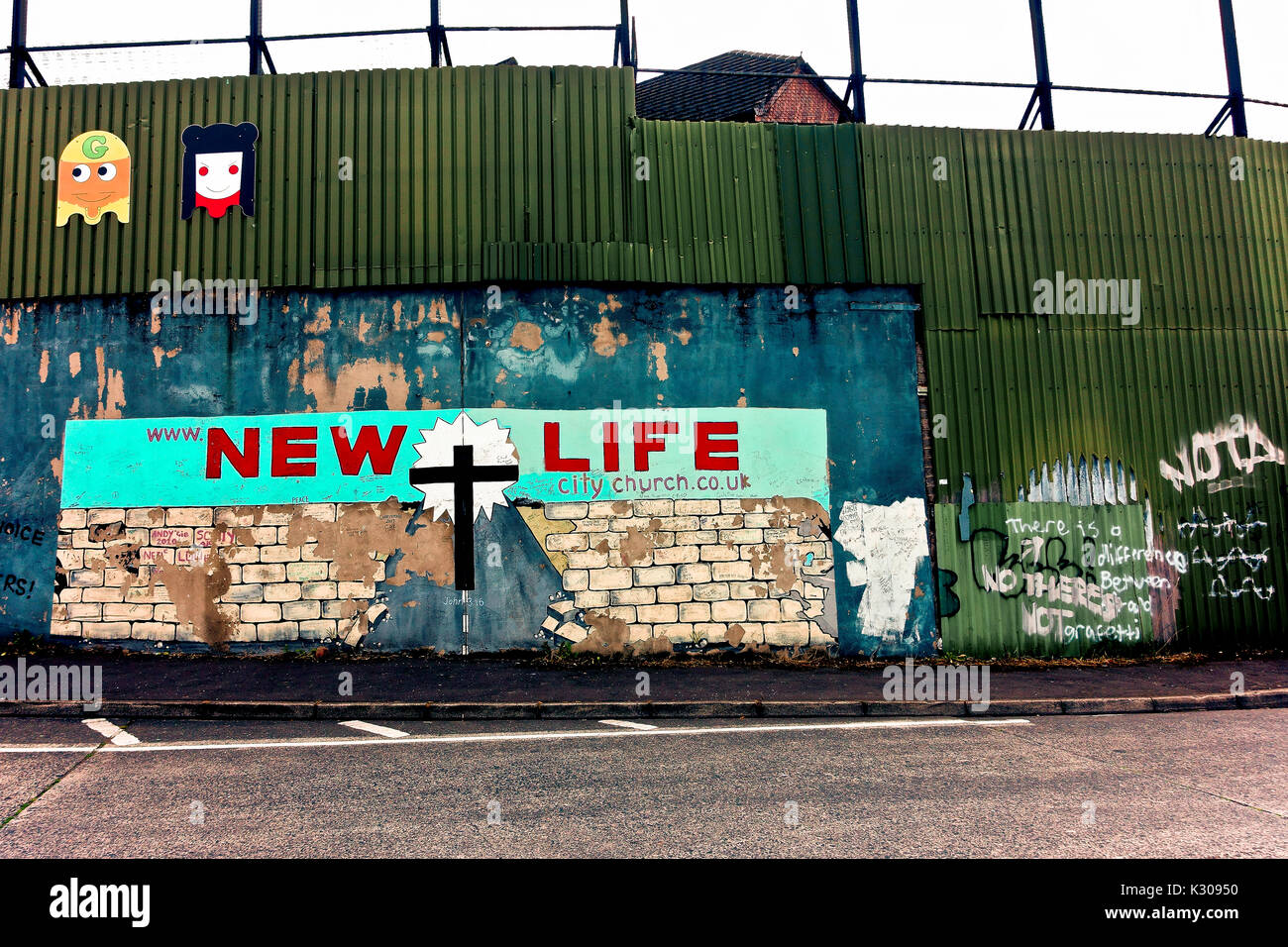 Political graffiti mural along the peace wall. New Life City Church. Belfast, Northern Ireland, United Kingdom, UK, Europe. Stock Photo