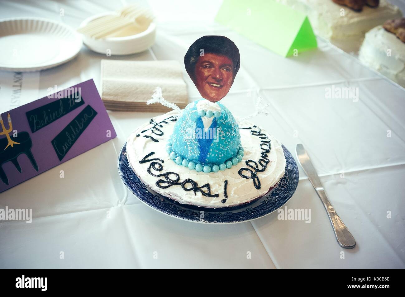 Submission for Read It and Eat It contest, and edible book festival at Milton S Eisenhower Library, Johns Hopkins University, showing a cake with a cut out face of Liberace atop a turquoise body form, with frosted text written all around, for the theme 'Behind the Candelabra, ' Baltimore, Maryland, April, 2016. Courtesy Eric Chen. Stock Photo