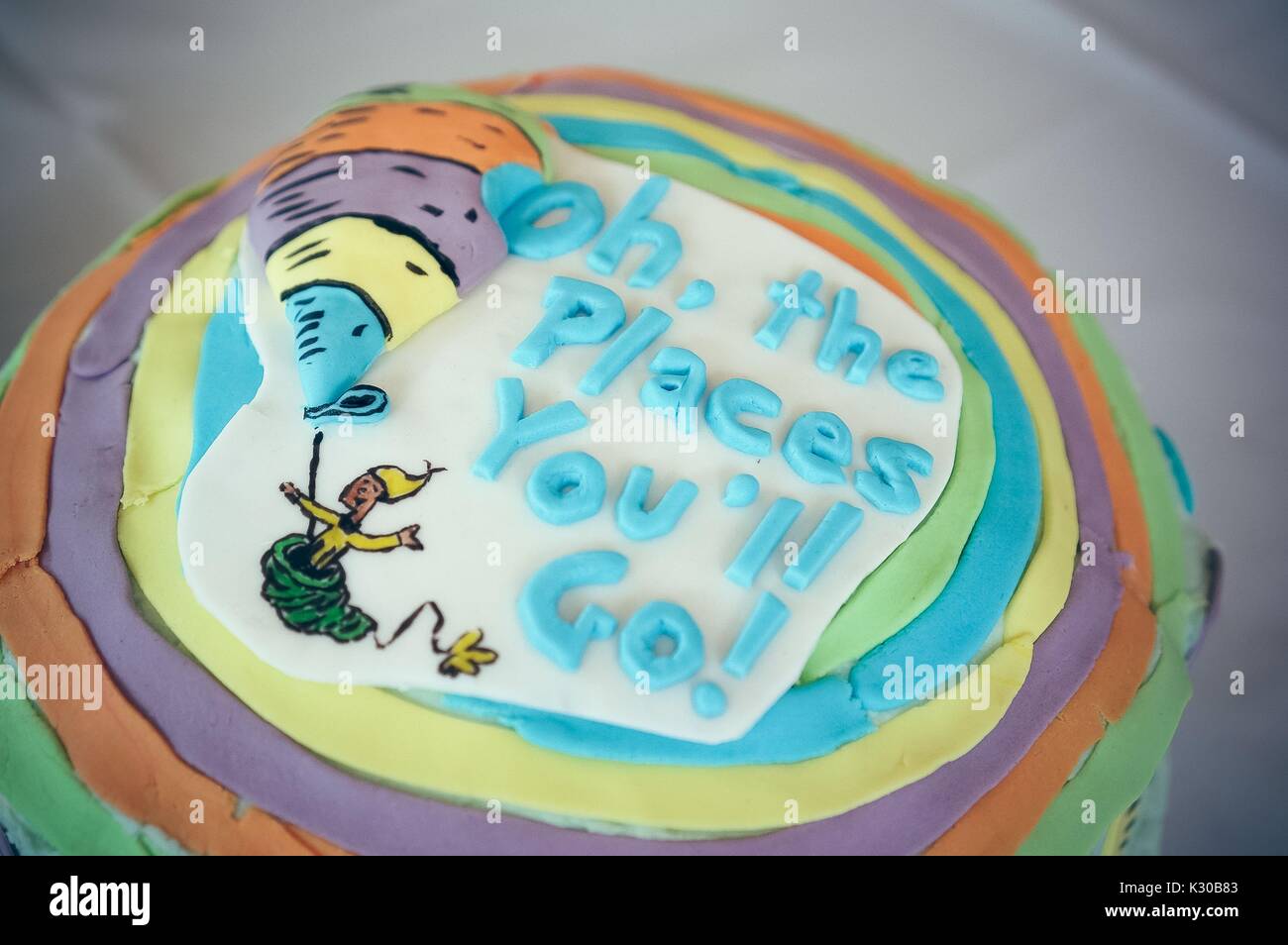 Submission for Read It and Eat It contest, and edible book festival at Milton S Eisenhower Library, Johns Hopkins University, showing a cake decorated with the cover from Dr Seuss's 'Oh, the Places You'll Go, ' with text and hot air balloon, Baltimore, Maryland, April, 2016. Courtesy Eric Chen. Stock Photo