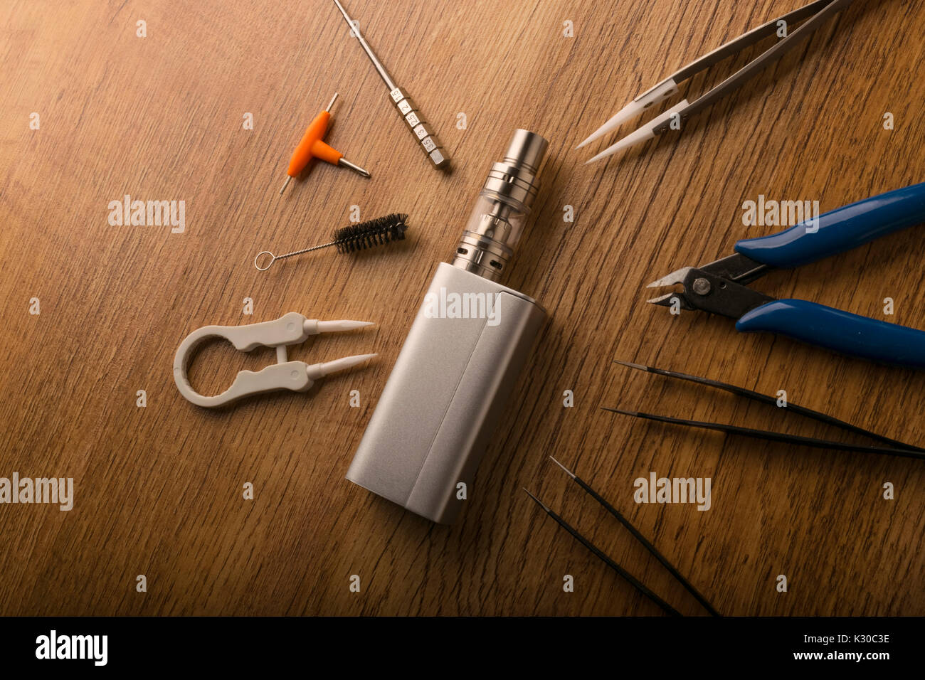 tools for vaping device, electronic cigarette, e-cigarette, box mod,  accessories isolated over a wooden background. for vaping shops Stock Photo  - Alamy