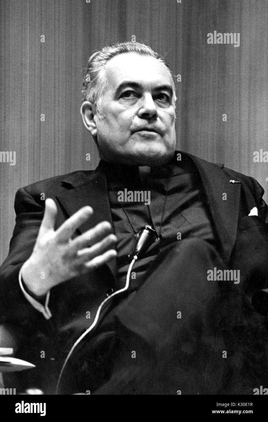 A half body portrait of Father Theodore Hesburgh looking serious at the American University Symposium, Washington DC, February 21, 1976. Stock Photo