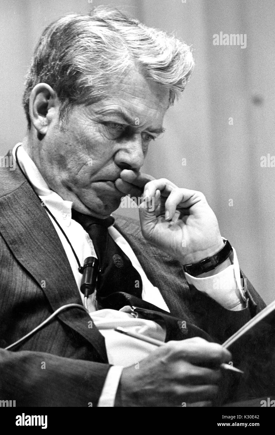 A half body portrait of editor in chief of Time Inc Hedley Donovan concentrating on what he is reading at the American University Symposium, Washington DC, February 21, 1976. Stock Photo