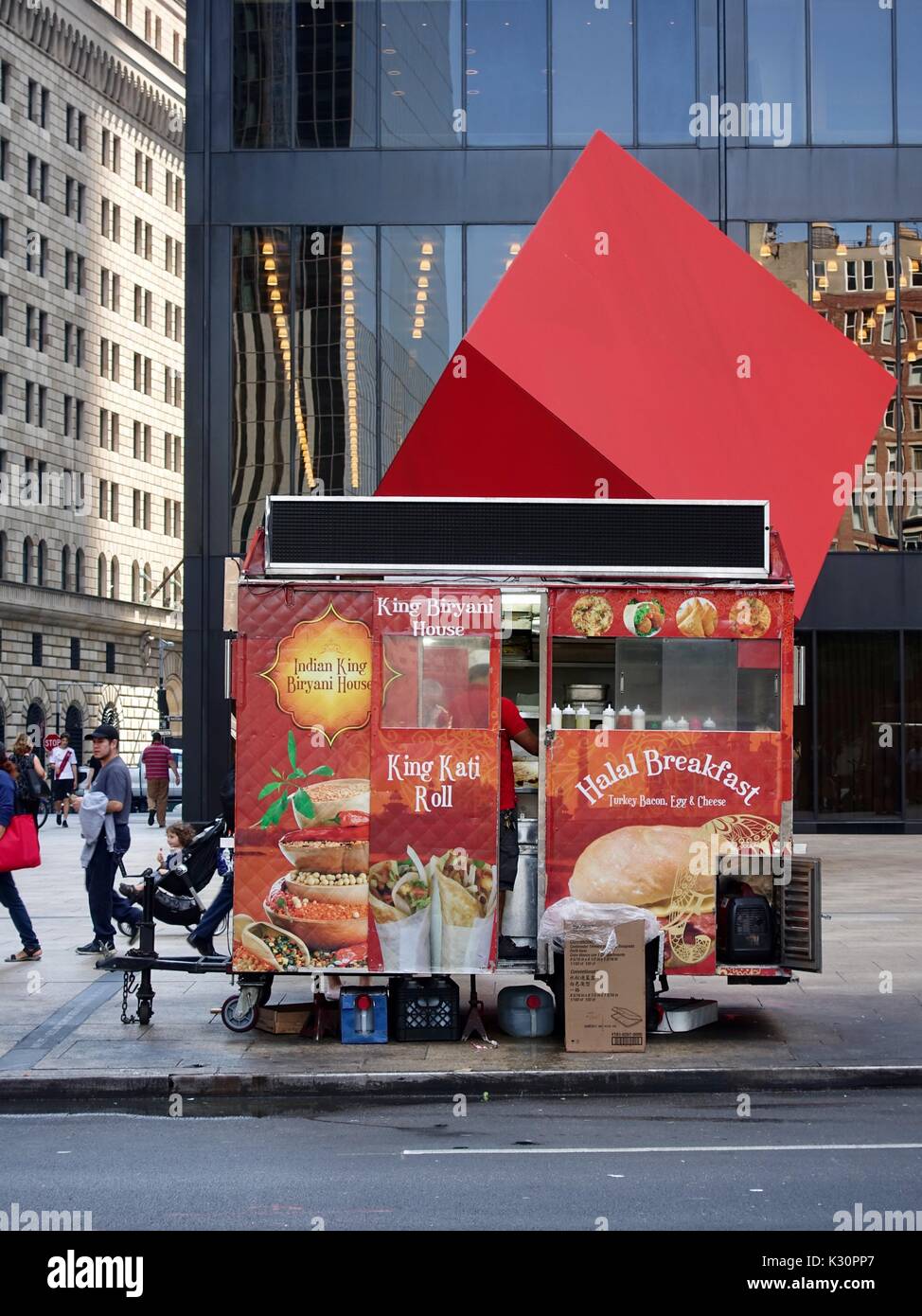 Indian King Biryani House food cart, with vendor inside cooking, parked in front of Red Cube on Broadway, New York, NY, USA. Stock Photo