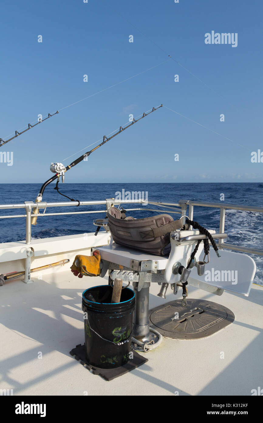 Fighting chair and bucket set up and with fishing gear on offshore boat in Pacific Ocean. Stock Photo