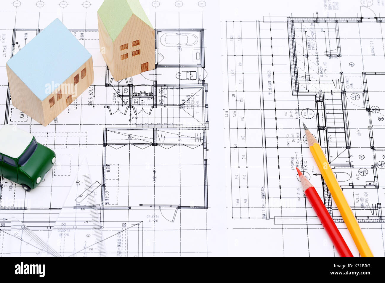 miniature model of house on blueprints, construction plan Stock Photo