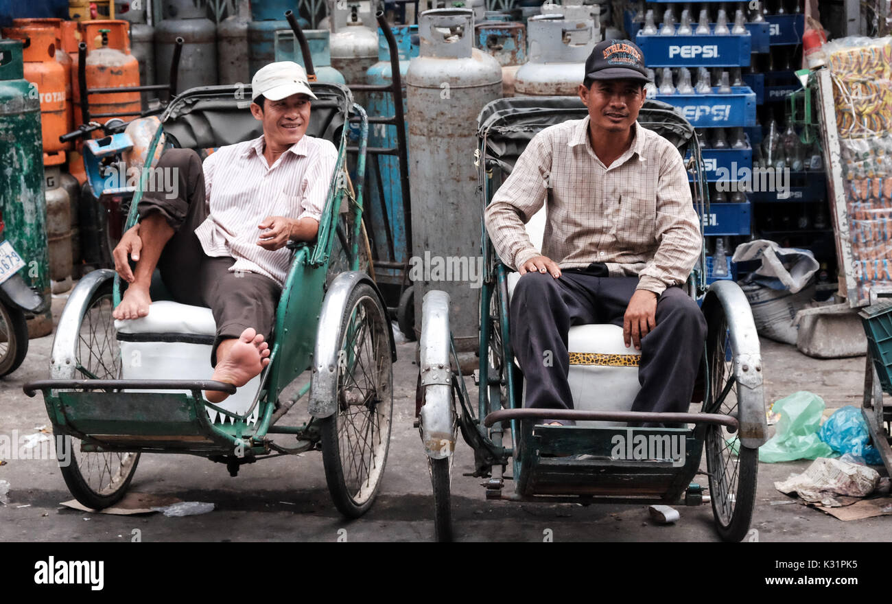 Pedicab risers wait for passengers, Phnom Penh, Cambodia Stock Photo