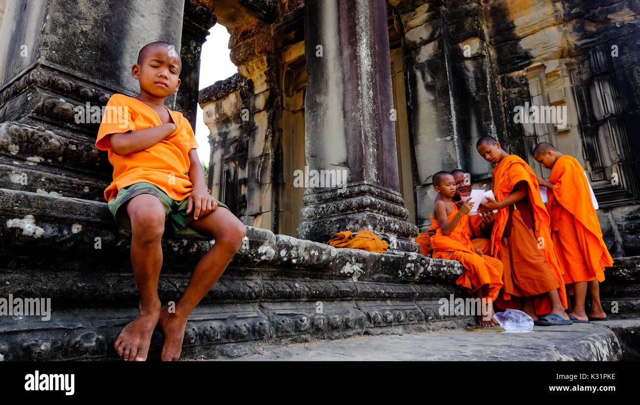 A Cambodian boy takes a nap at a temple in Angkor Wat, Cambodia Stock Photo