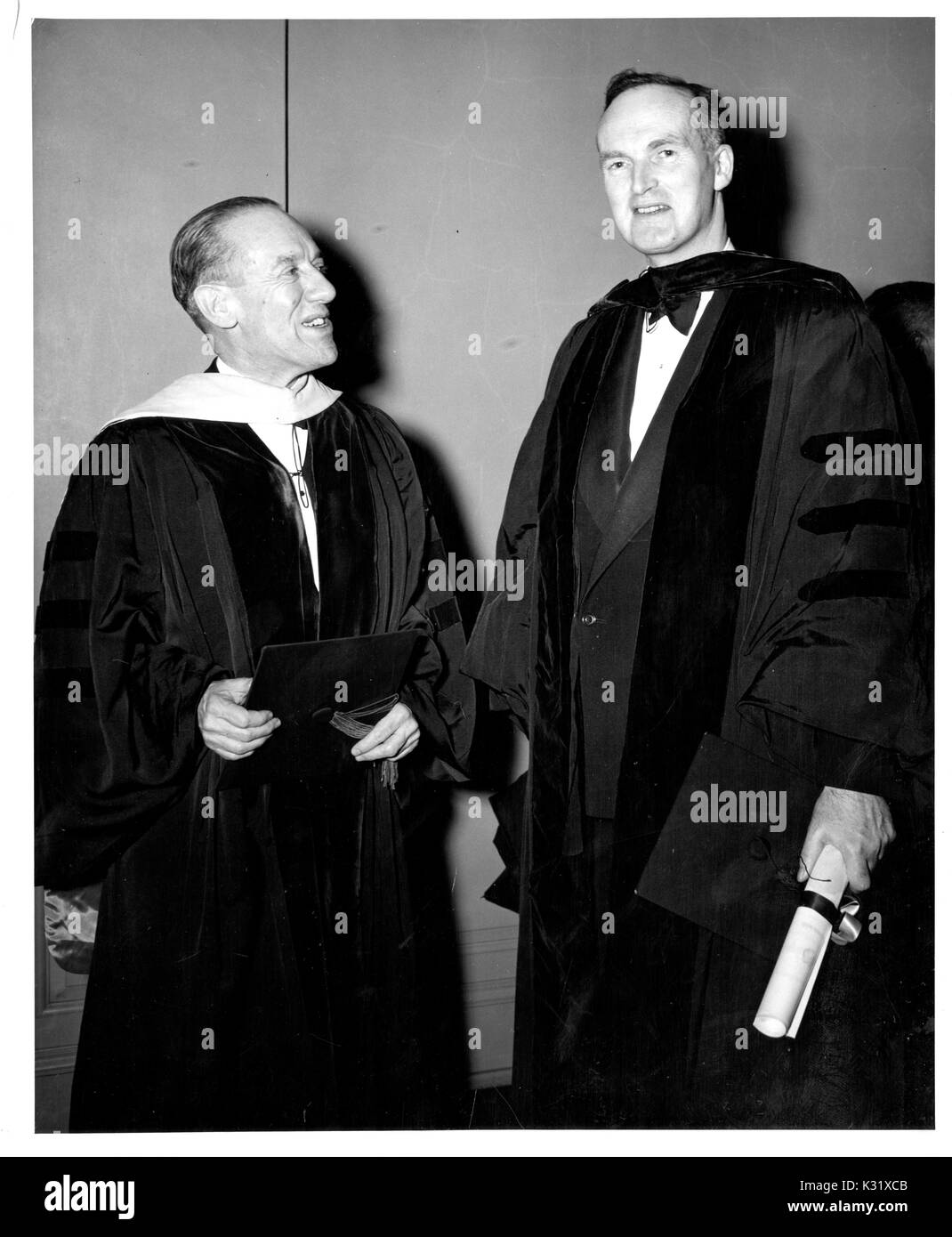 American scientist and President of Johns Hopkins University Detlev Wulf Bronk talks with Sir Oliver Franks, British Ambassador to the United States, at the university's commemoration day, celebrating the university's founding, in Baltimore, Maryland, 1950. Stock Photo