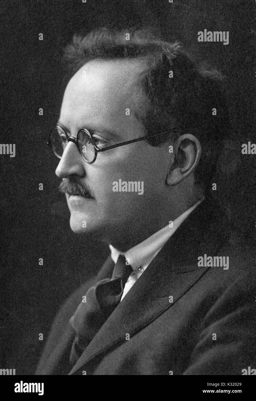 Sepia portrait photograph, profile and shoulders up, of Samuel Claggett Chew, published fellow and professor of English and French at Johns Hopkins University, wearing glasses, tie, and jacket, Baltimore, Maryland, 1927. Stock Photo