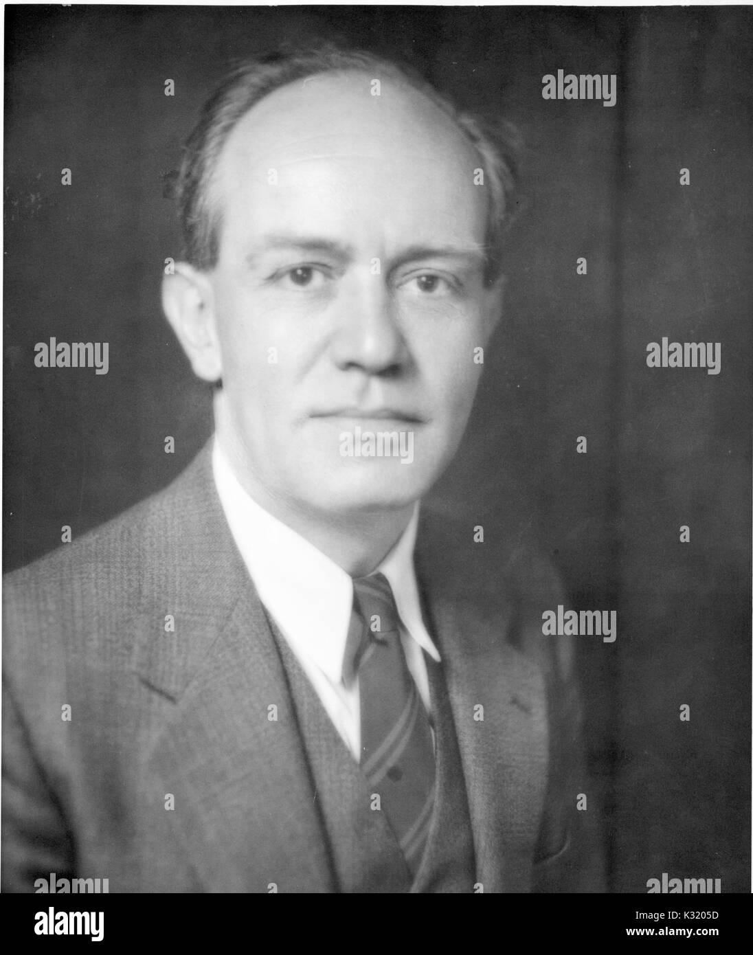 A chest up portrait of prominent geologist Ernst Cloos wearing a suit and tie at 41 years of age, 1940. Stock Photo