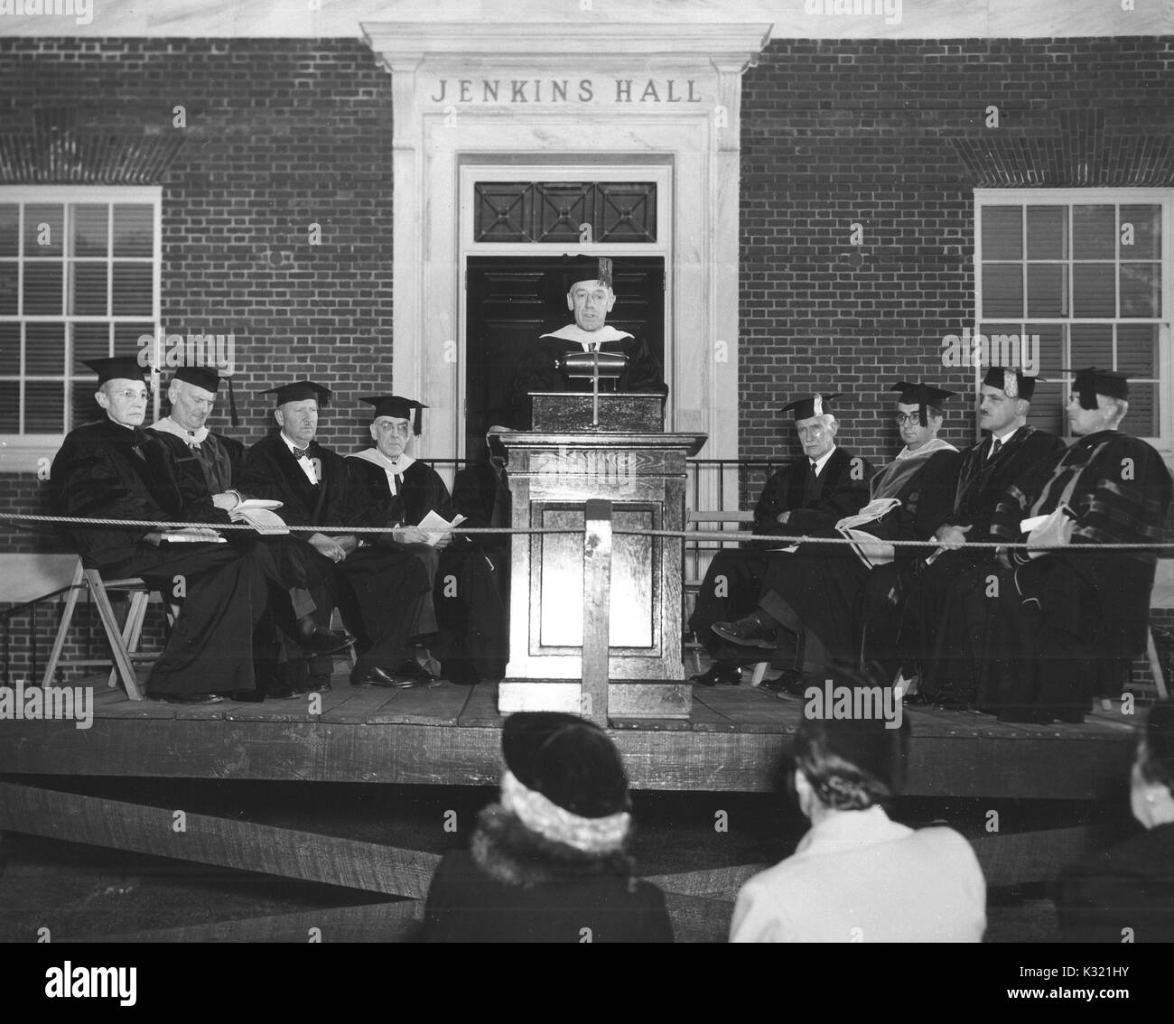 American scientist Detlev Wulf Bronk stands at a podium while speaking in front of Jenkins Hall, an academic building on the Homewood campus of Johns Hopkins University, where he served as president, in Baltimore, Maryland, 1950. Stock Photo