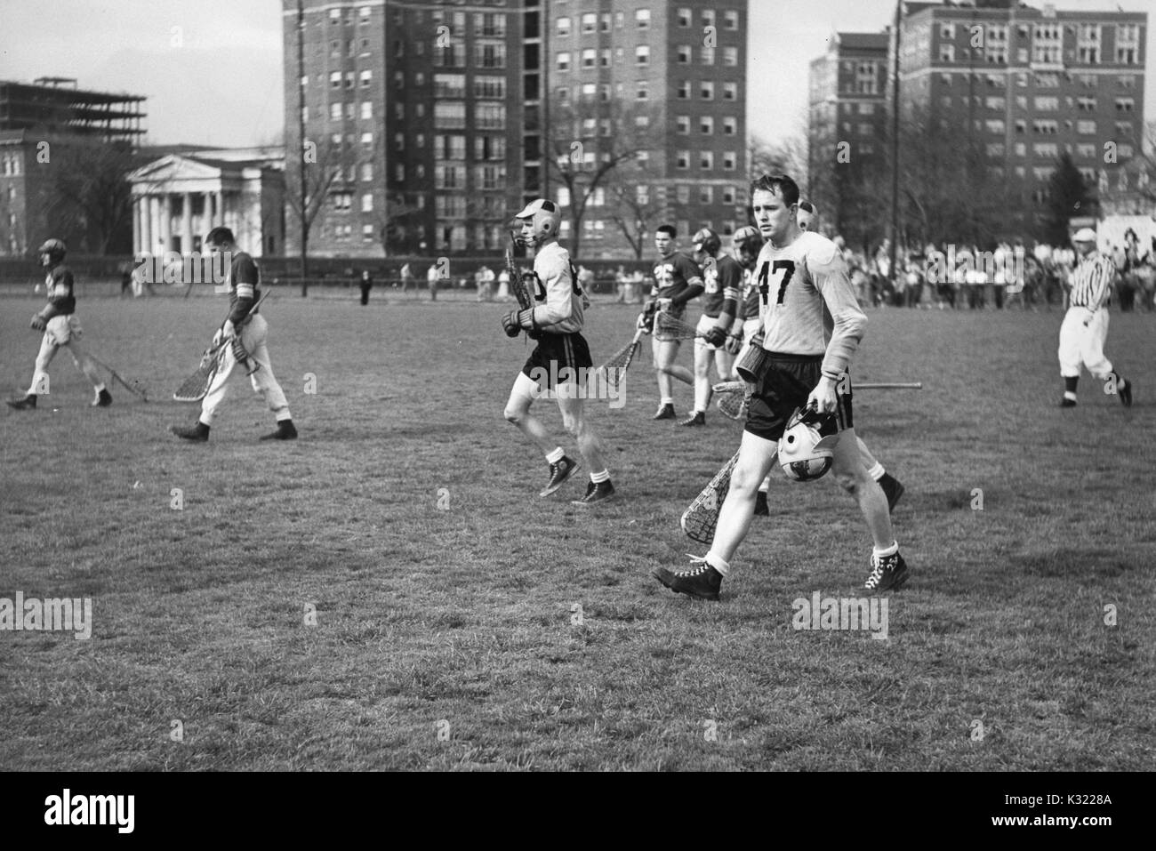 Loyola and Johns hopkins lacrosse players, including Johns Hopkins Co-captain and attackman Byron Forbush (no, 1951. 47), are scattered across the Homewood Field in Baltimore, Maryland. Stock Photo