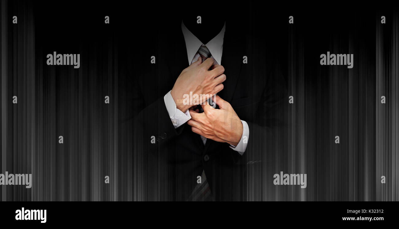 Businessman in black suit on panoramic black background Stock Photo