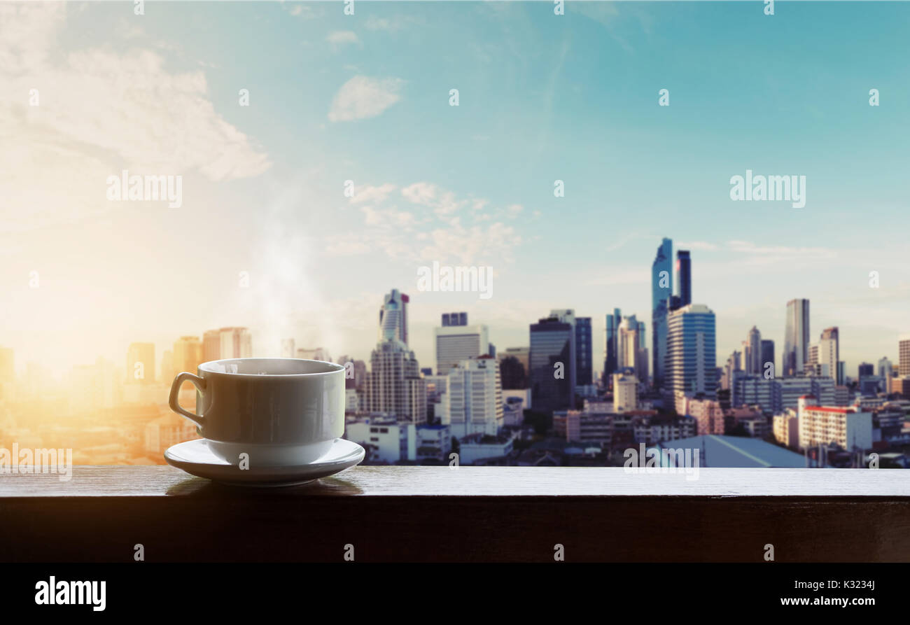 Morning hot coffee in sunrise, city backgrounds Stock Photo