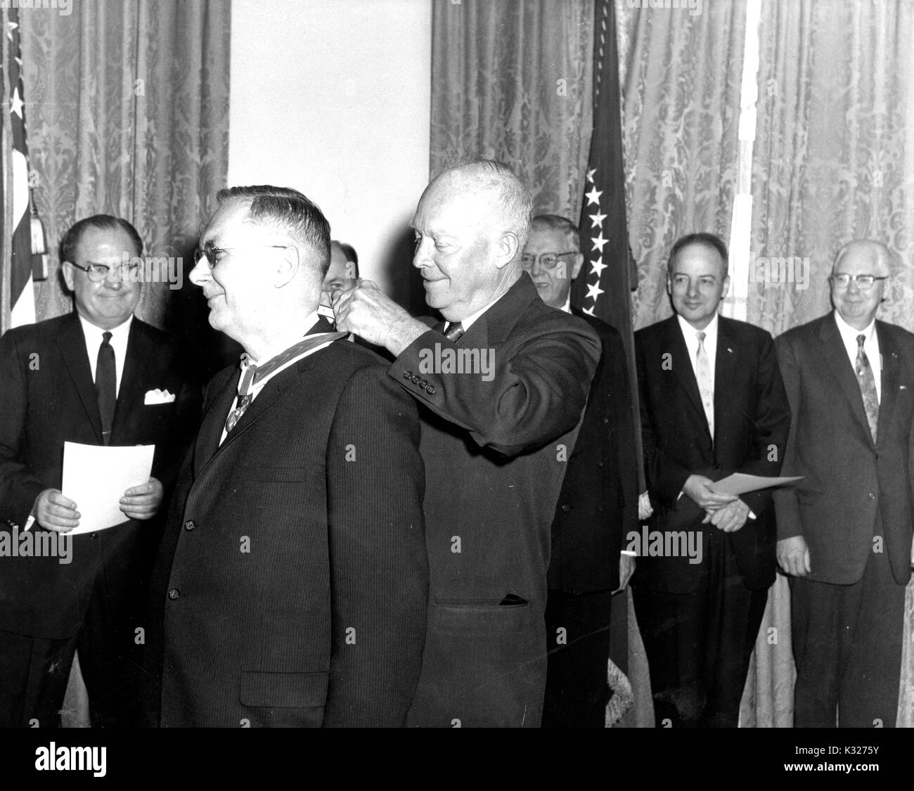American aeronautical scientist and NASA Deputy Administrator Hugh Latimer Dryden (left) receives an award from President Dwight D Eisenhower in front five other unidentified award recipients, 1960. Stock Photo