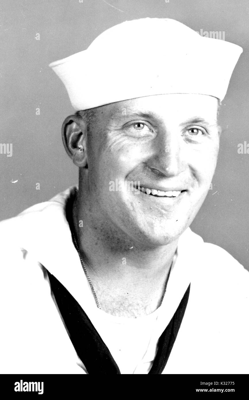 Shoulders up portrait of Donald Burke Downing, member of Johns Hopkins University's undergraduate class of 1940, in US Navy uniform around the time of graduation, 1940. Stock Photo
