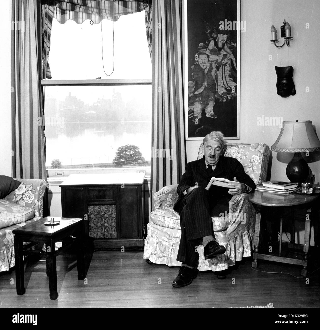 Candid portrait of American philosopher, psychologist, and educational reformer John Dewey sitting in his home reading, 1946. Stock Photo