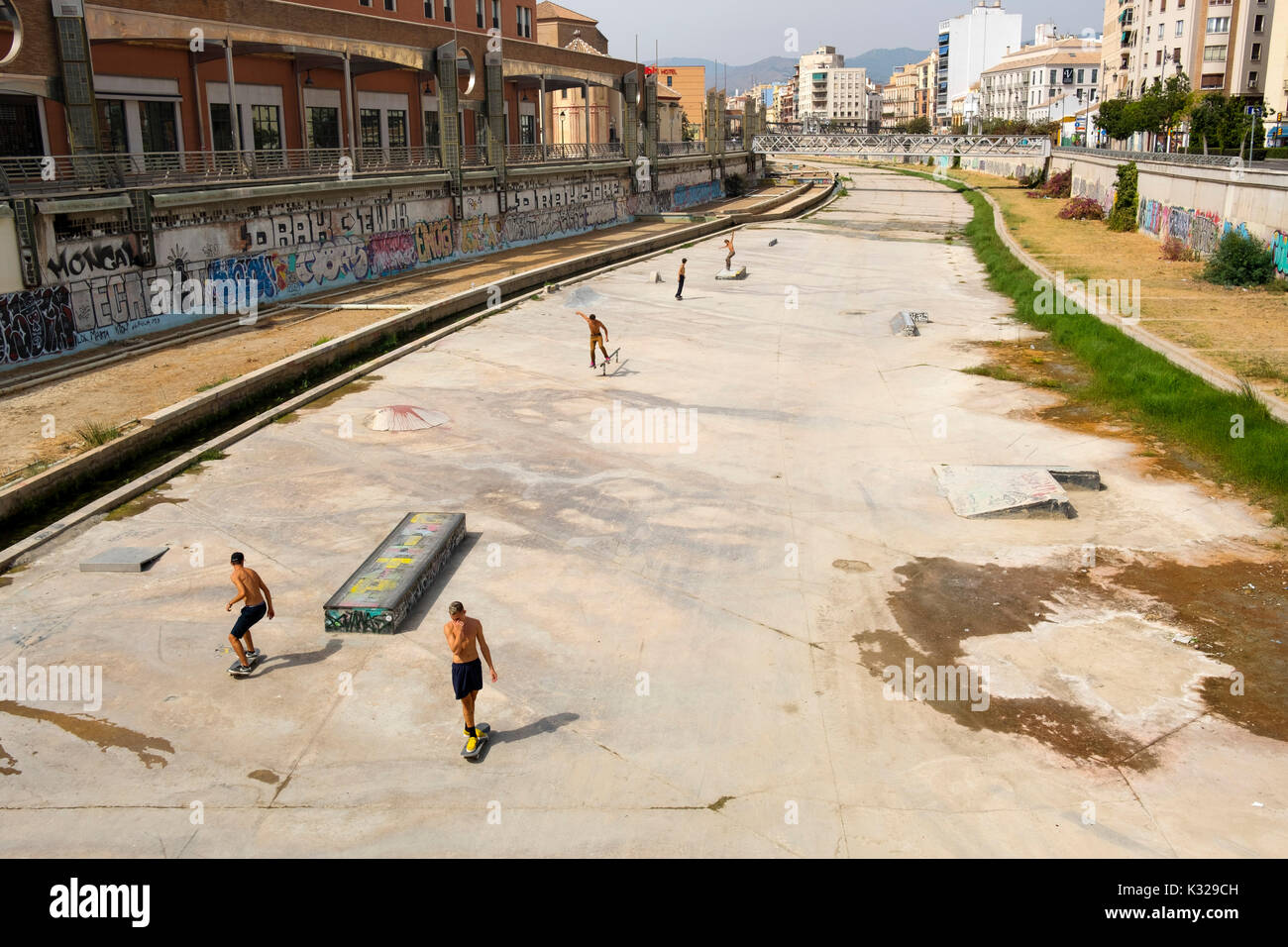 Skateboarders at Guadalmedina river channel, Malaga city, Costa del Sol, Andalusia southern Spain, Europe Stock Photo