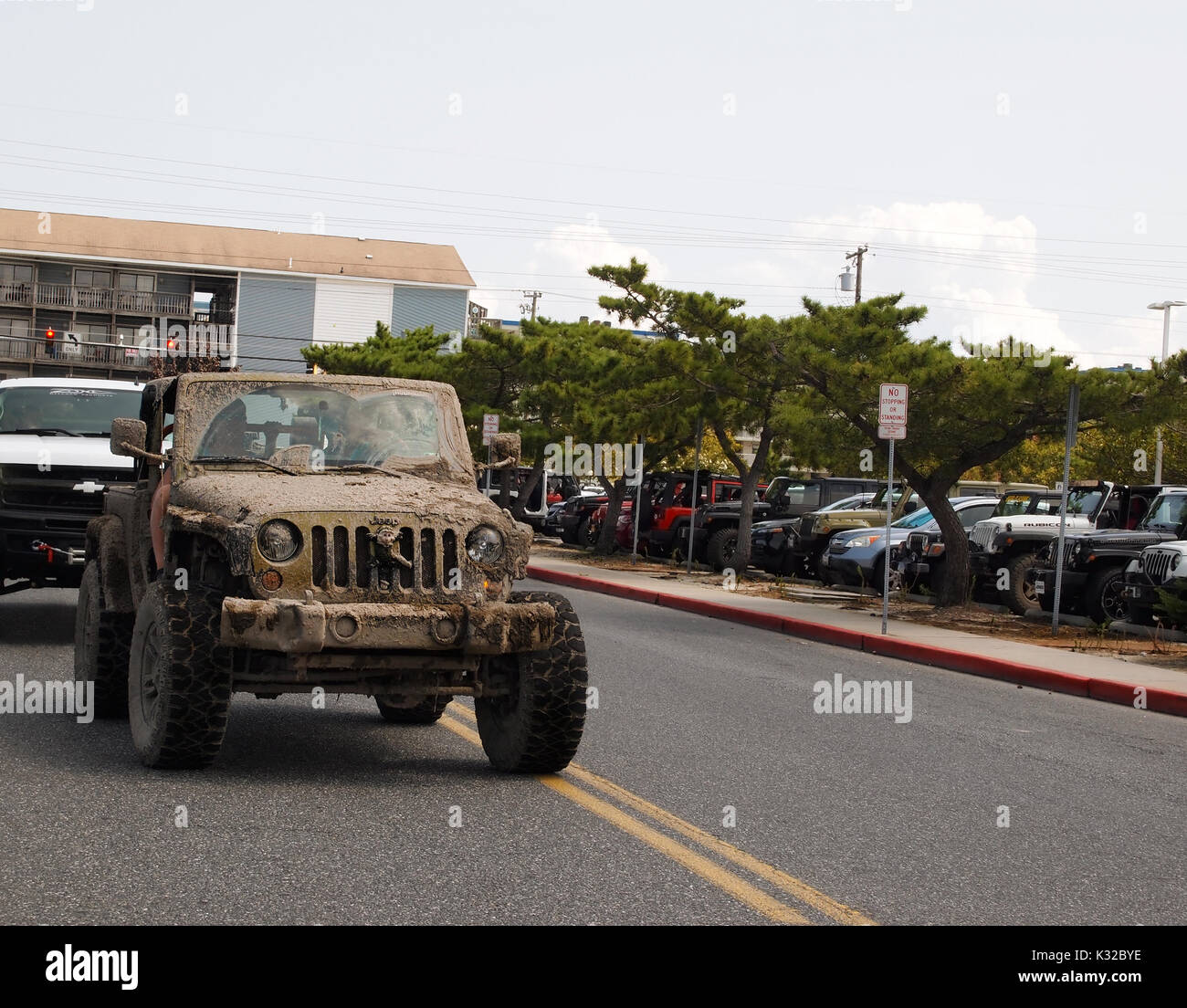 OCEAN CITY, MD - AUGUST 26, 2017: A vintage Jeep covered thick dried mud arrives at the Roland E. Powell Convention Center on Saturday afternoon of Je Stock Photo