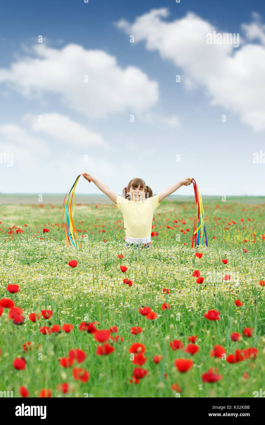 happy little girl on wild flowers meadow Stock Photo - Alamy