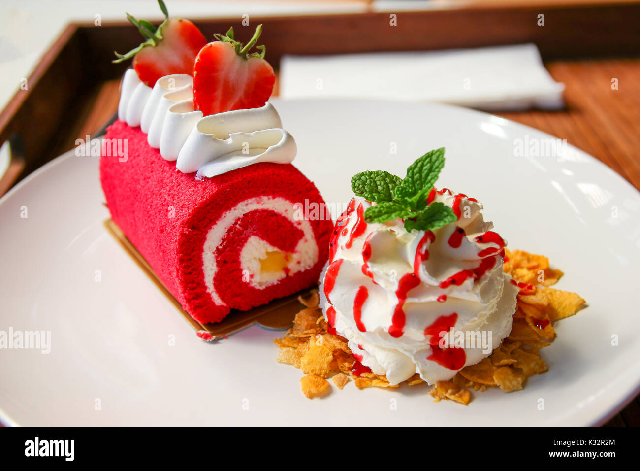 Strawberry on red velvet cake roll with whipping Cream and cereal on