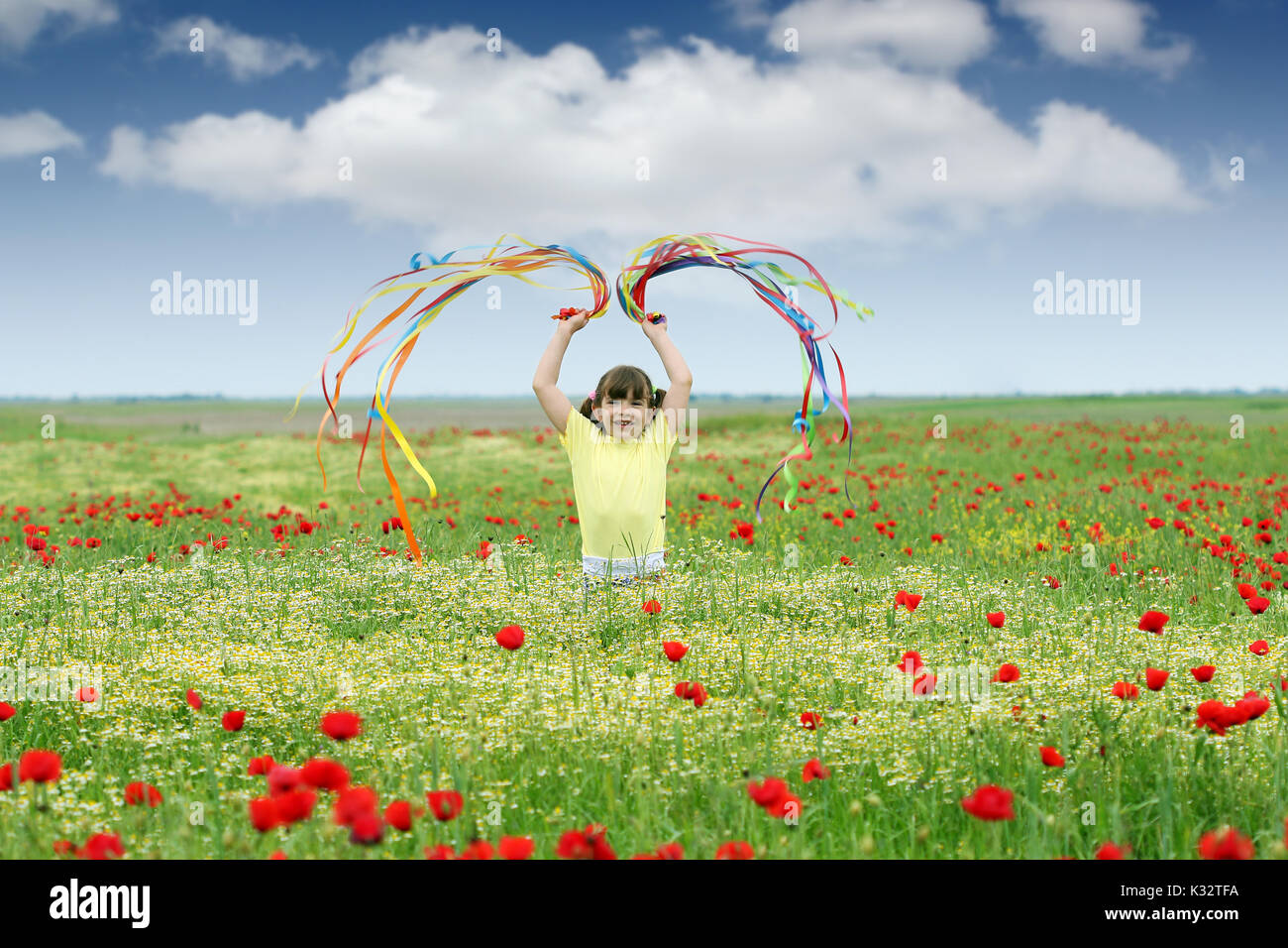 happy little girl on meadow spring season Stock Photo - Alamy