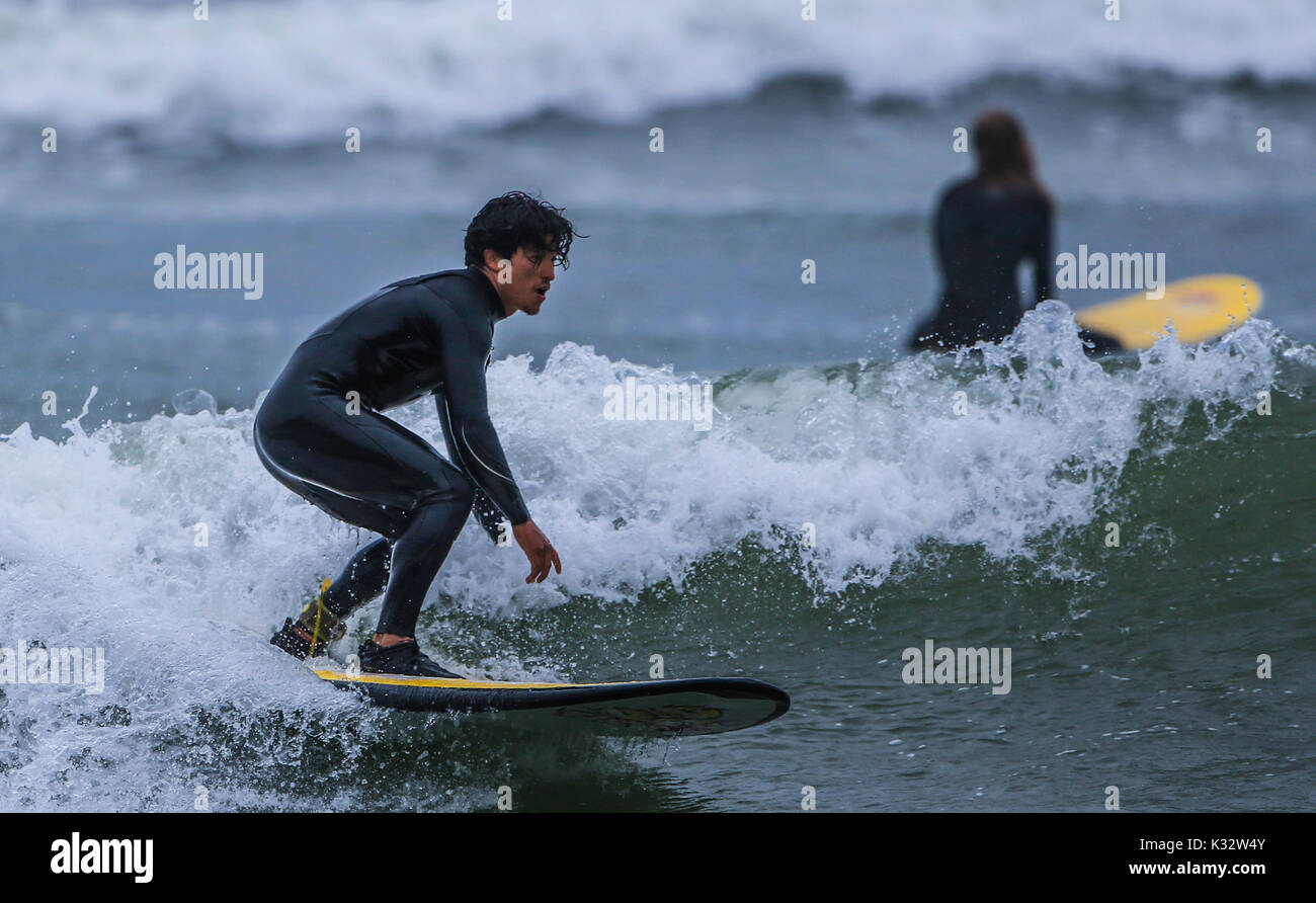 Surfing at Waikiki Beach in the tourist area of Miraflores in the capital city of Lima in Peru. Surfers, waves, sea, blue, ocean. sea South Pacific Stock Photo