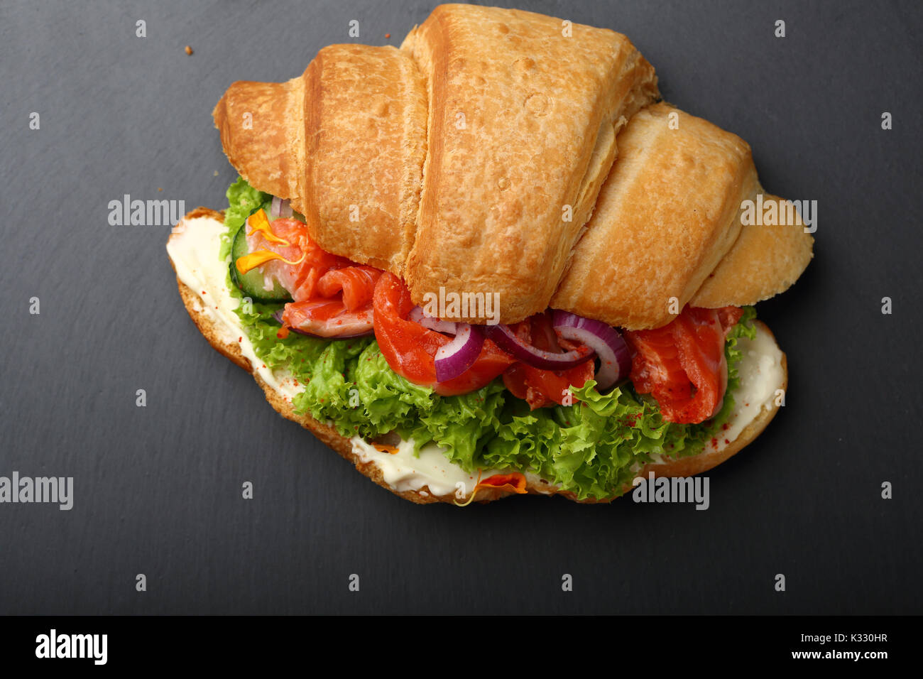 Croissant sandwitch with salmon, food top view slate background Stock ...