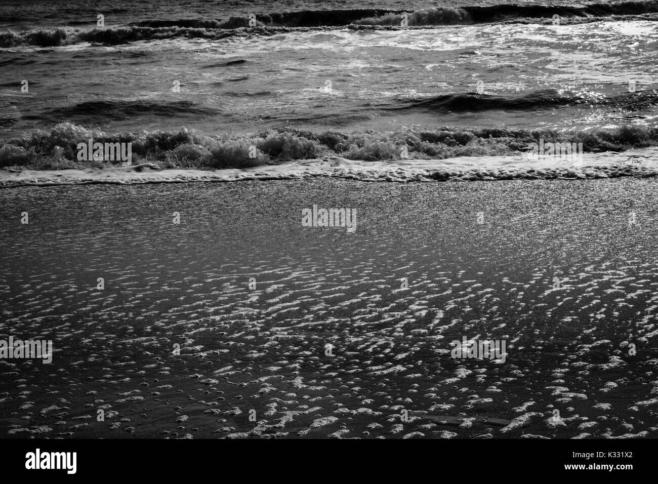 The brisk waves brushing up against the shore Stock Photo