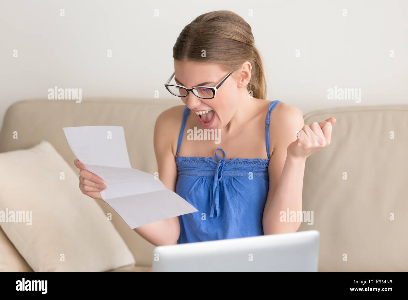Happy smiling lady reading letter with good news Stock Photo
