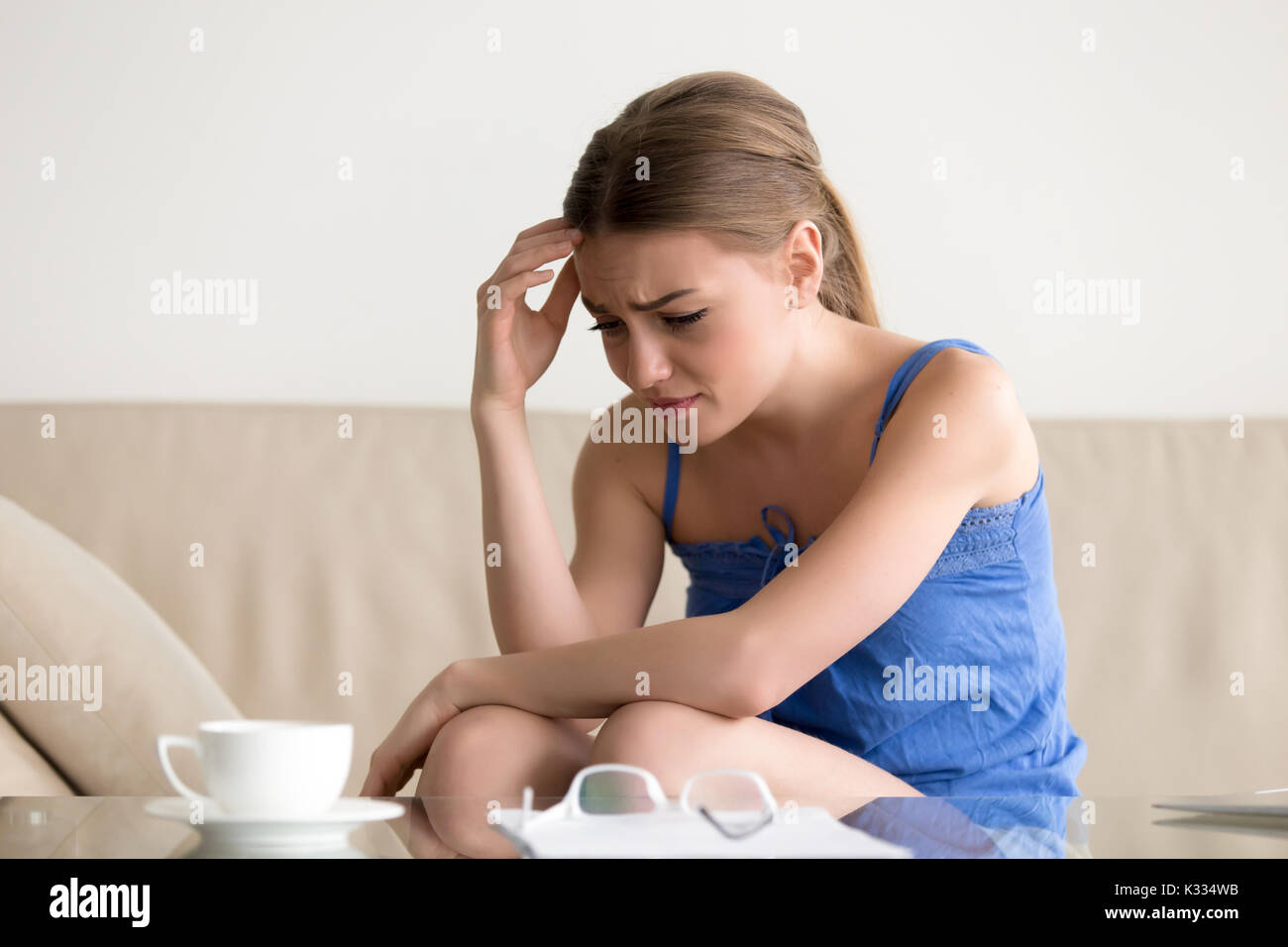 Woman feeling upset because of loan debt letter Stock Photo