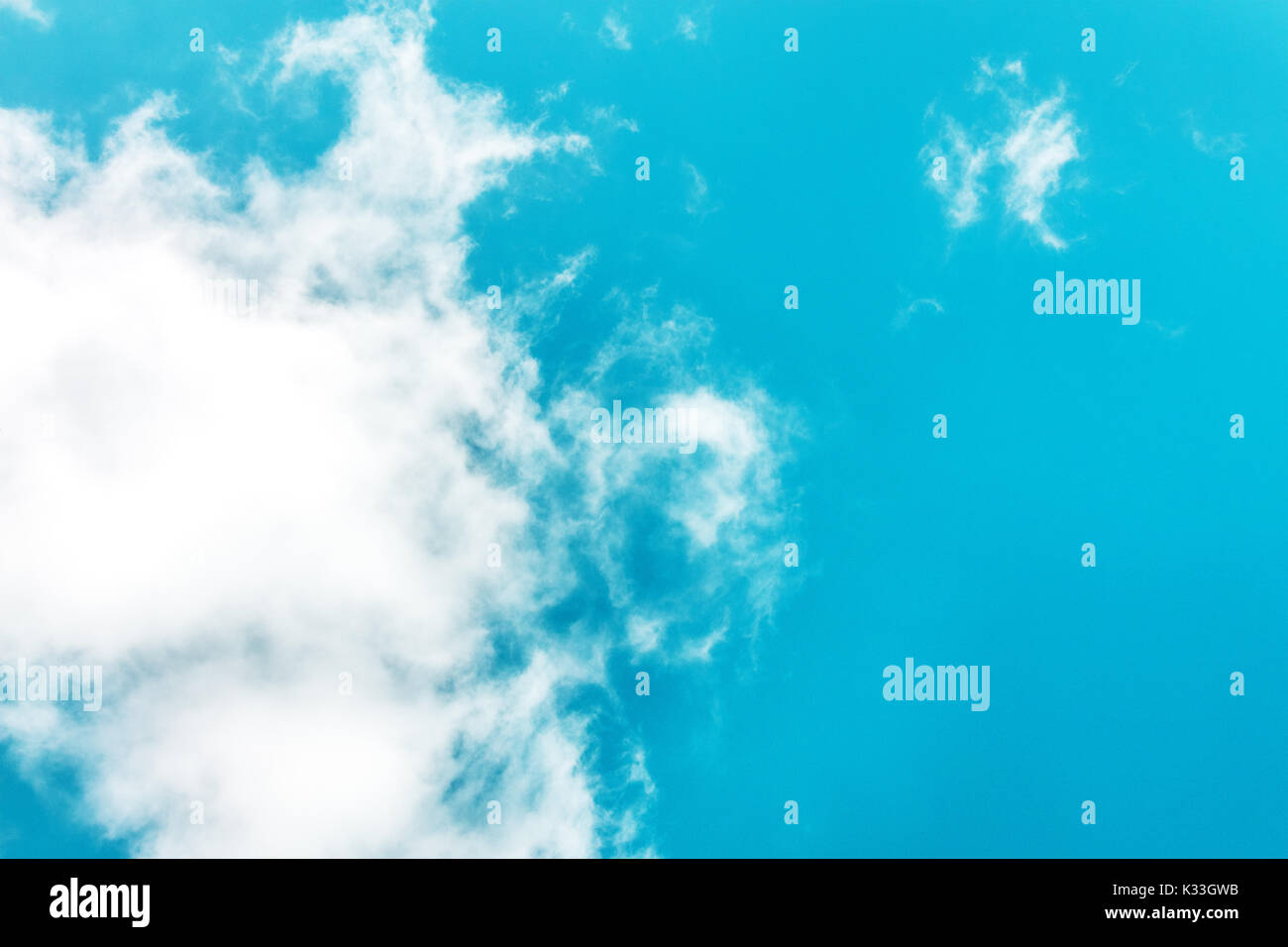 Teal blue sky with white clouds and copyspace Stock Photo Alamy
