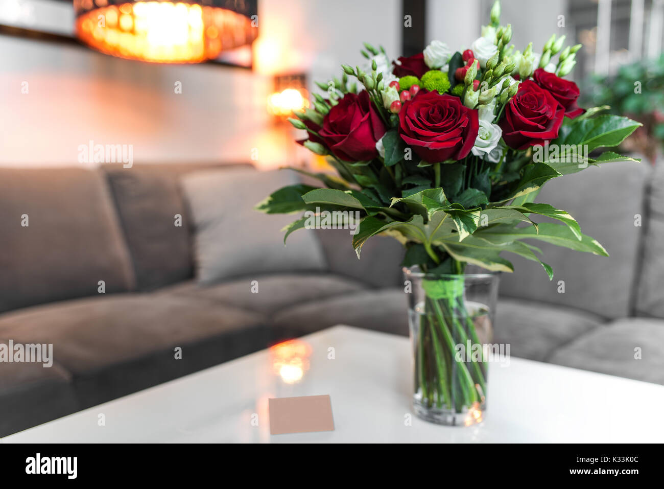 Bouquet of red Roses standing on the white table in the saloon Stock ...
