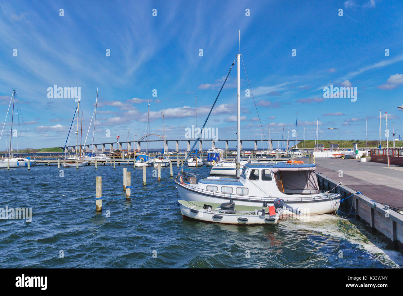 Boats in the Rudkobing harbor with the Langelandsbroen on the island Langeland, Denmark Stock Photo