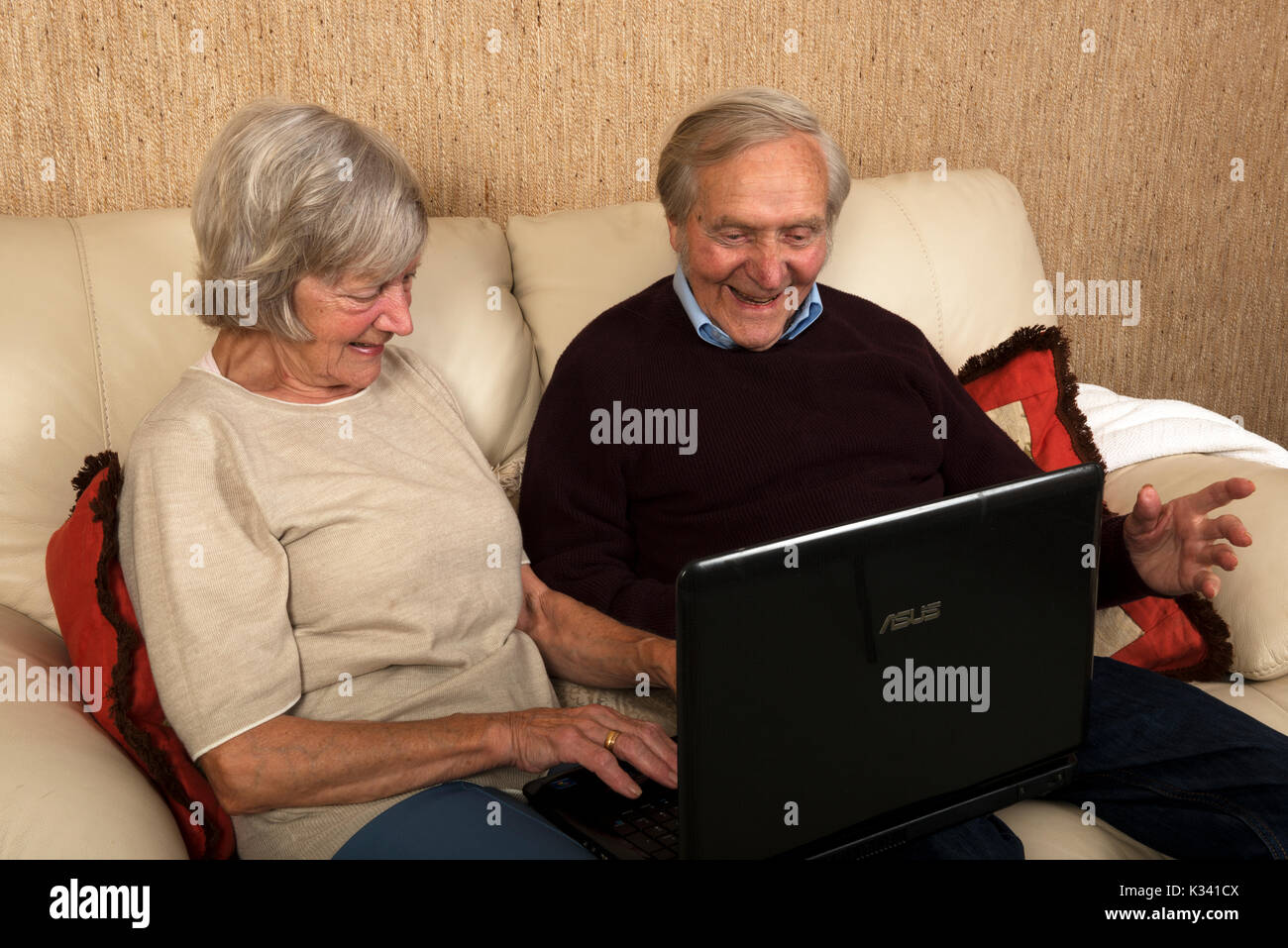 Elderly brother and sister using a laptop computer to send emails Stock Photo